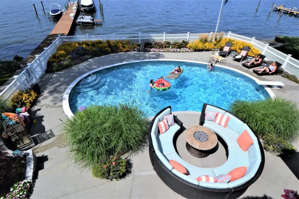 Overhead shot of backyard living space of lake living and inground swimming pool